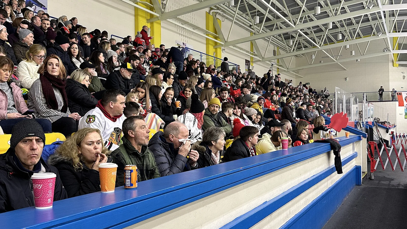 Ice hockey fans filling the stands inside an arena