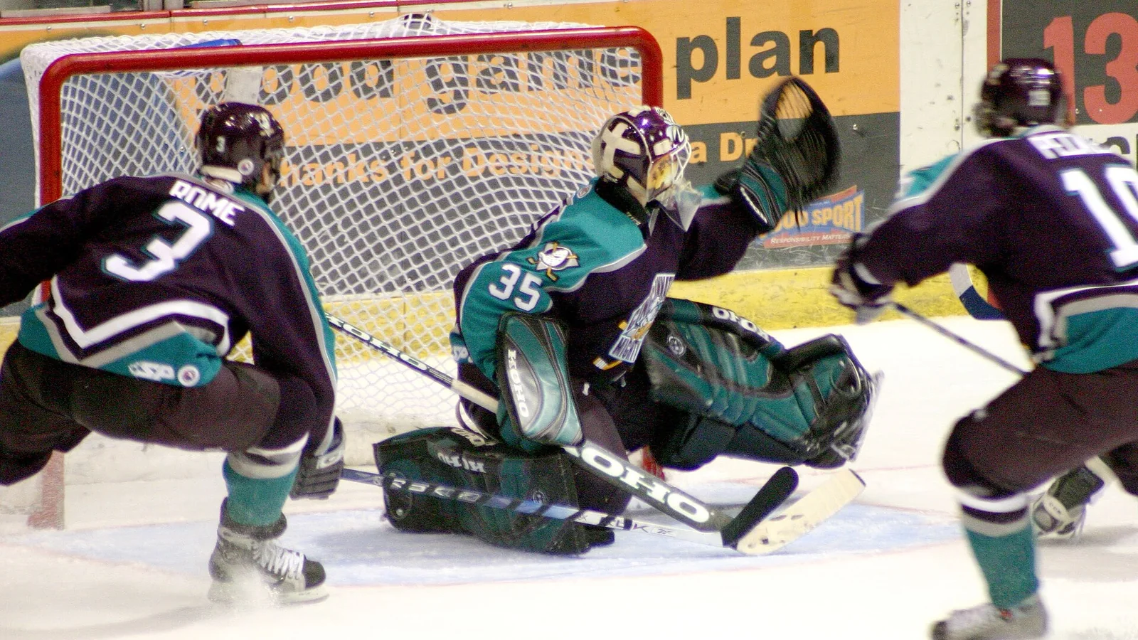 Ice hockey players crowd the goal during a game